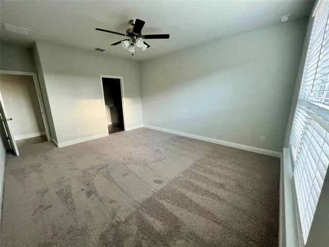 a view of a livingroom with a ceiling fan and window