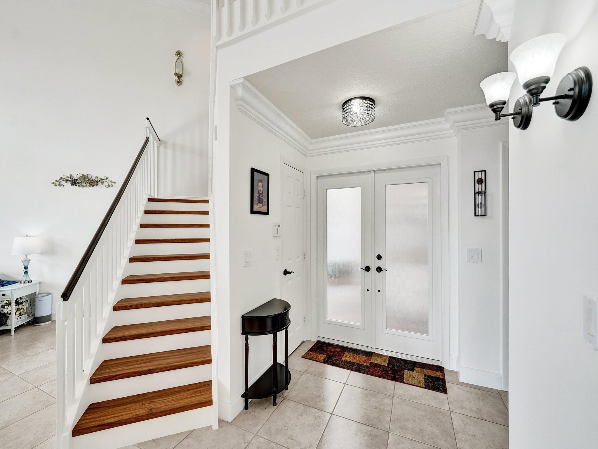 6298 Brava Way Boca Raton, FL 33433 - Photo 17 of 91 a view of a hallway with entryway and chandelier
