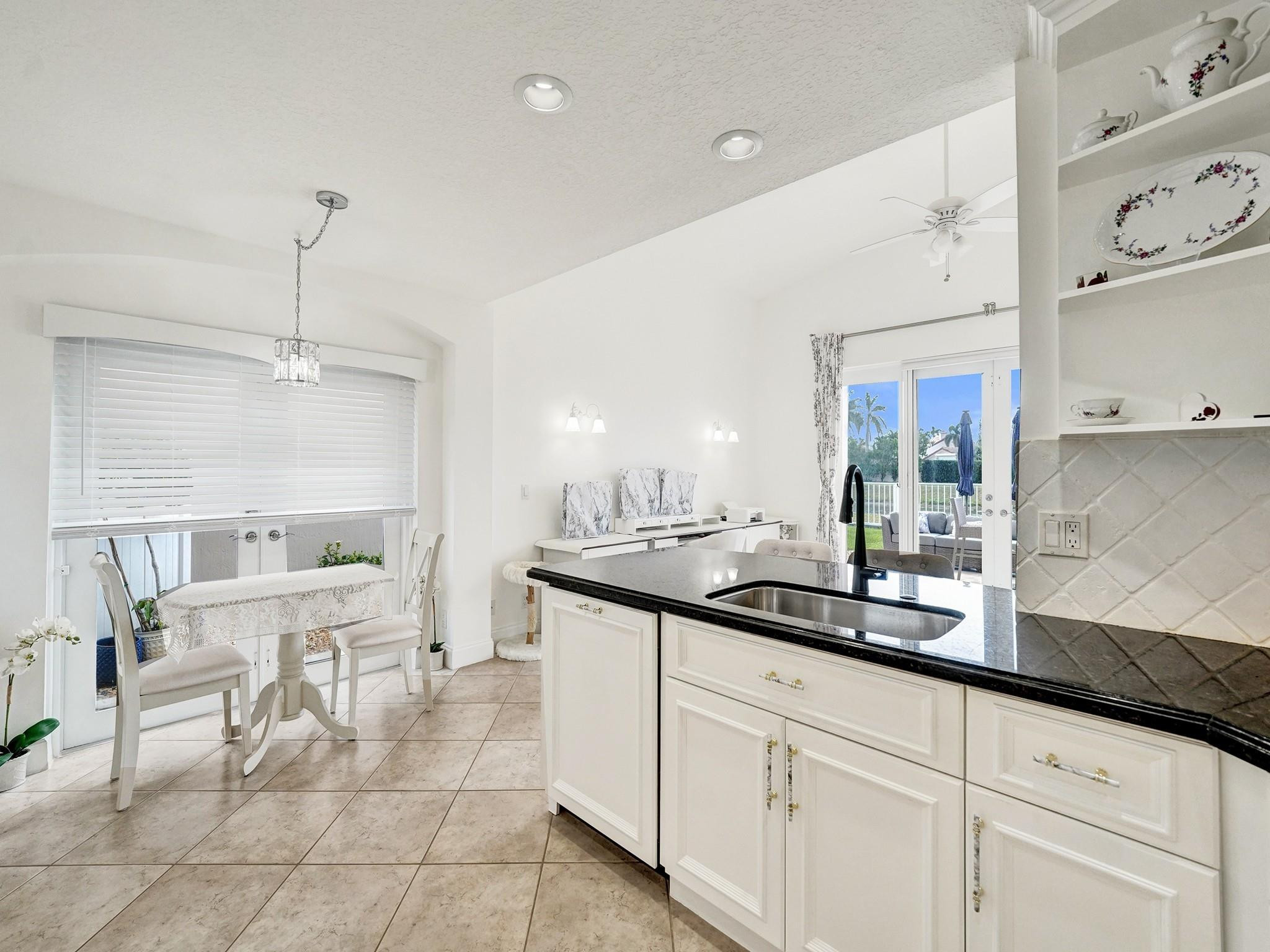 6298 Brava Way Boca Raton, FL 33433 - Photo 42 of 91 a kitchen with white cabinets and sink
