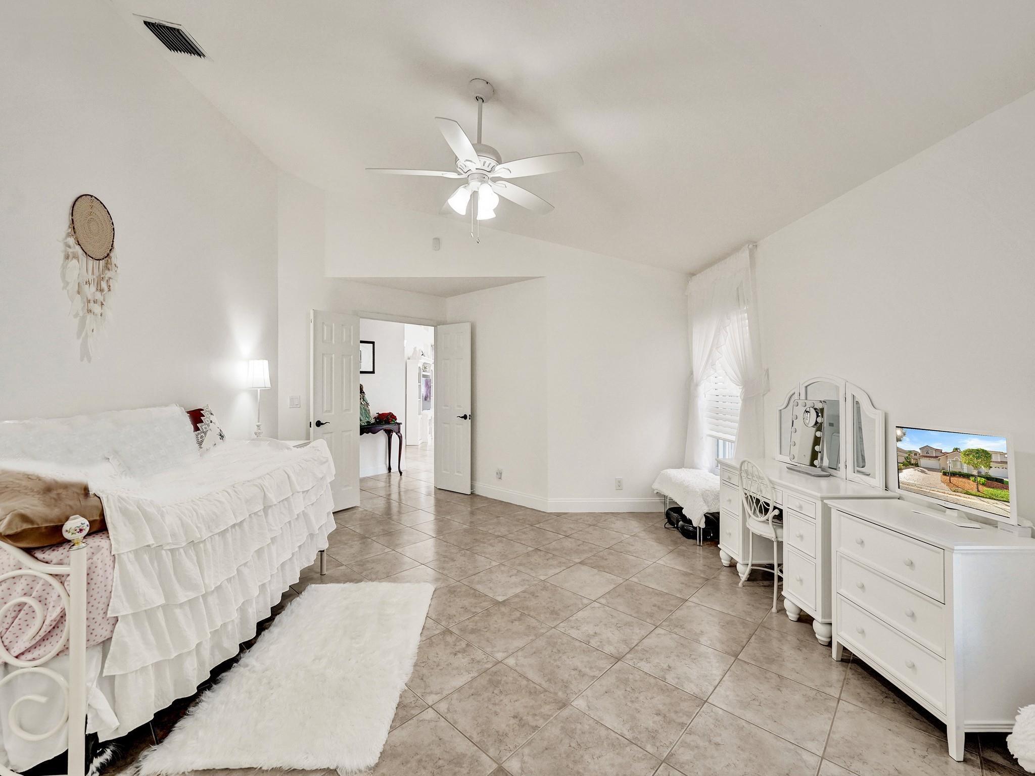 6298 Brava Way Boca Raton, FL 33433 - Photo 47 of 91 a bed room with a bed and a chandelier