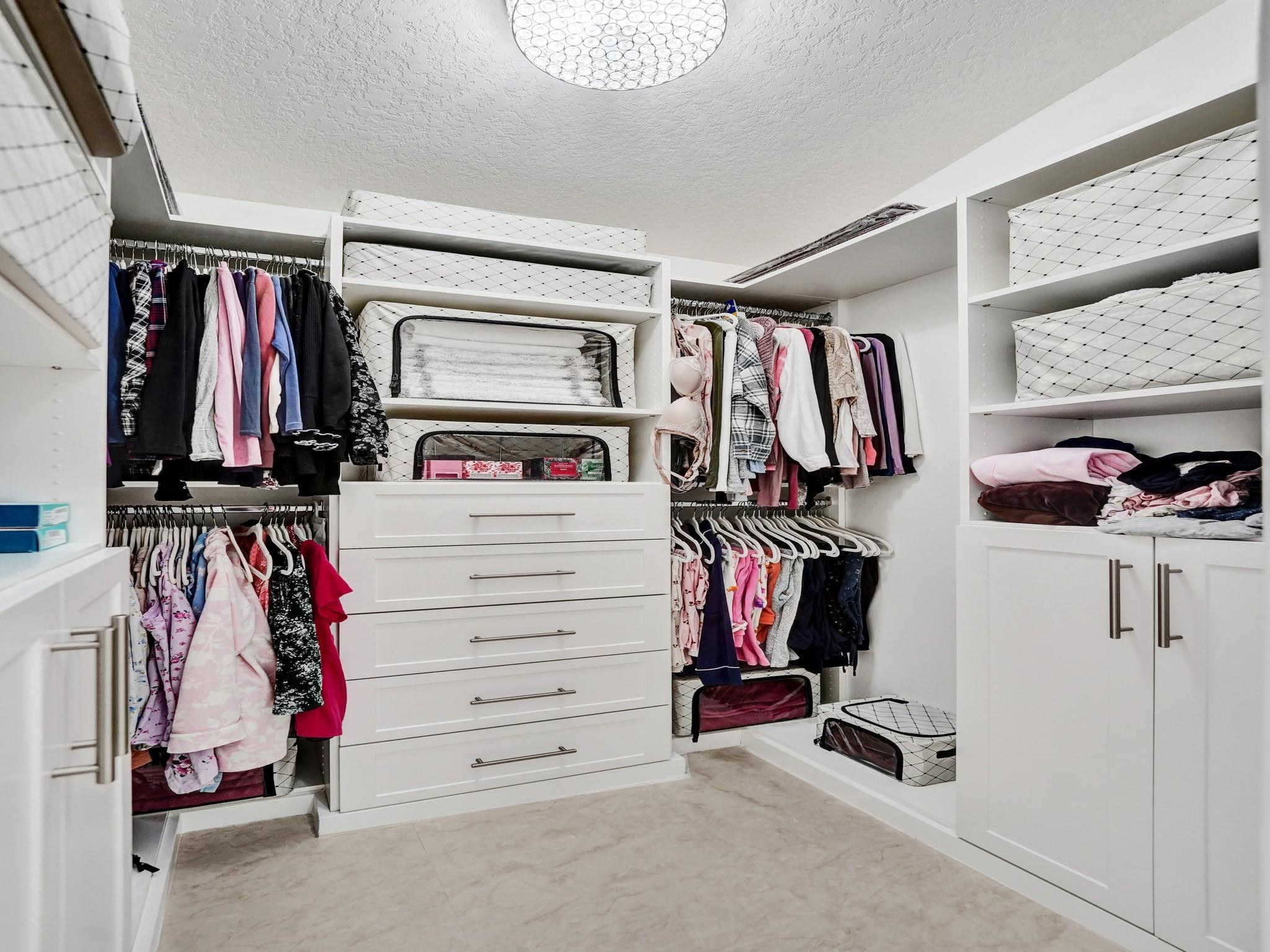6298 Brava Way Boca Raton, FL 33433 - Photo 49 of 91 a view of walk in closet with clothes and shoes