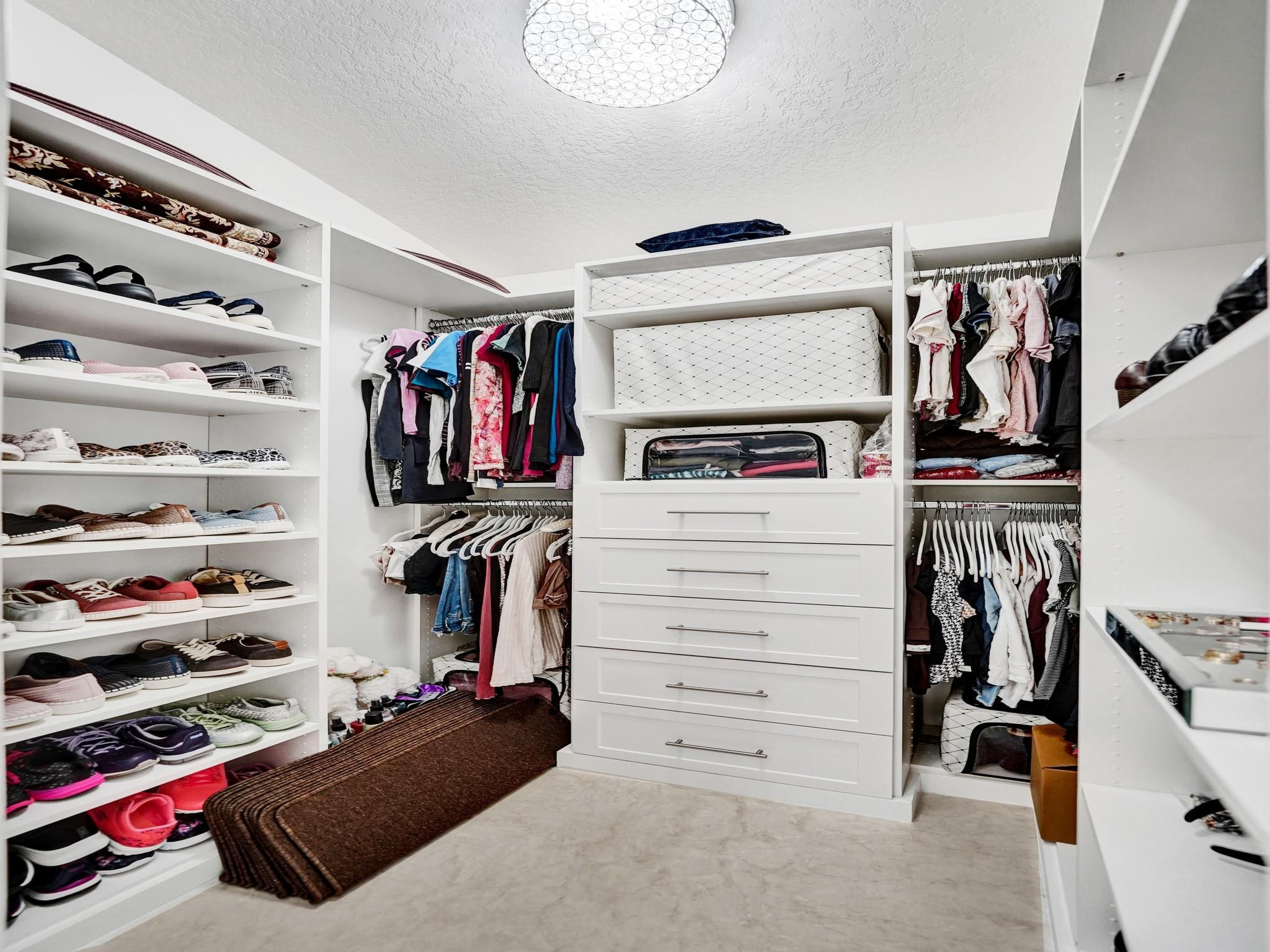 6298 Brava Way Boca Raton, FL 33433 - Photo 50 of 91 a view of walk in closet with clothes and shoes