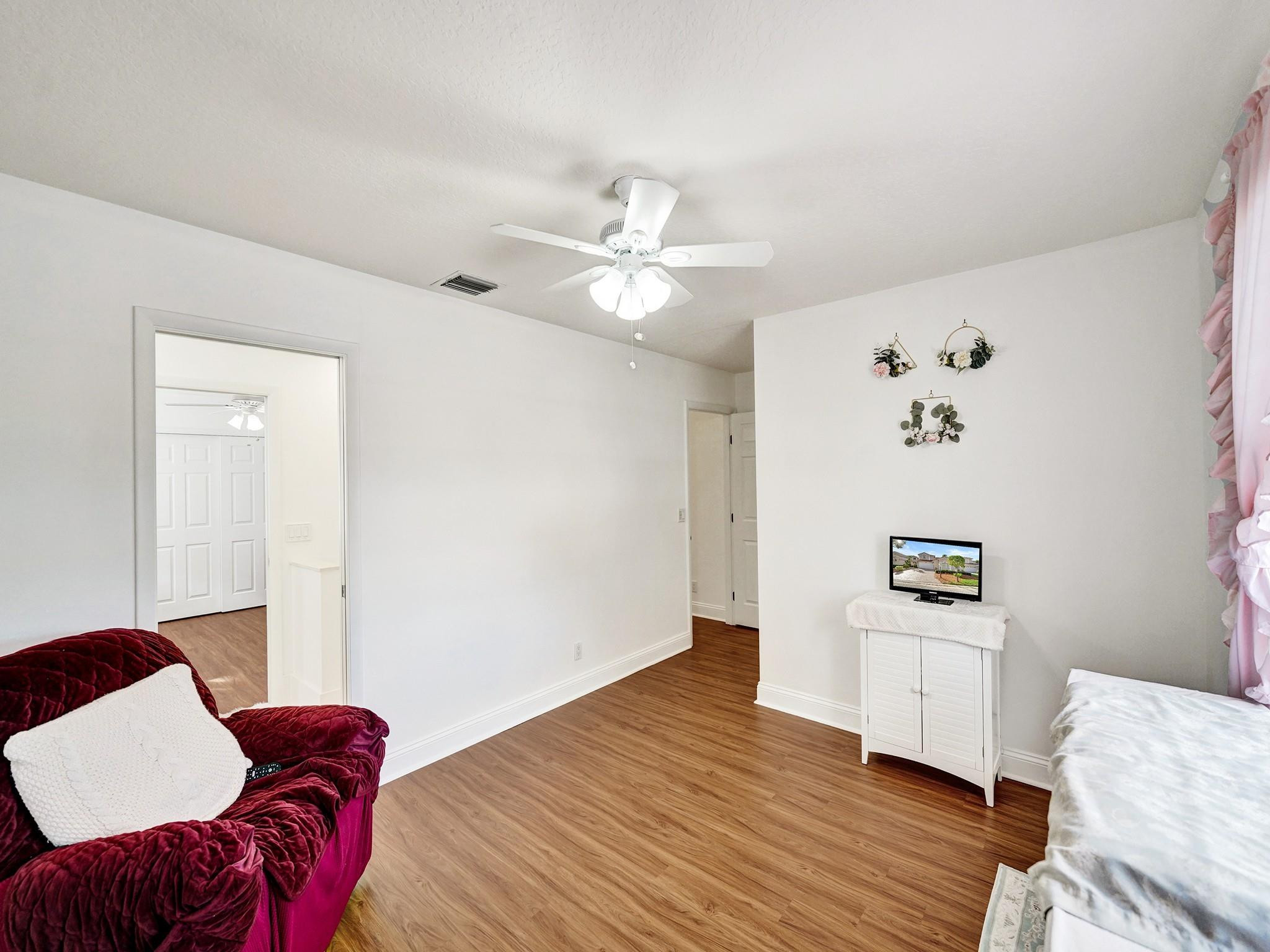 6298 Brava Way Boca Raton, FL 33433 - Photo 64 of 91 a bedroom with a bed and a chandelier