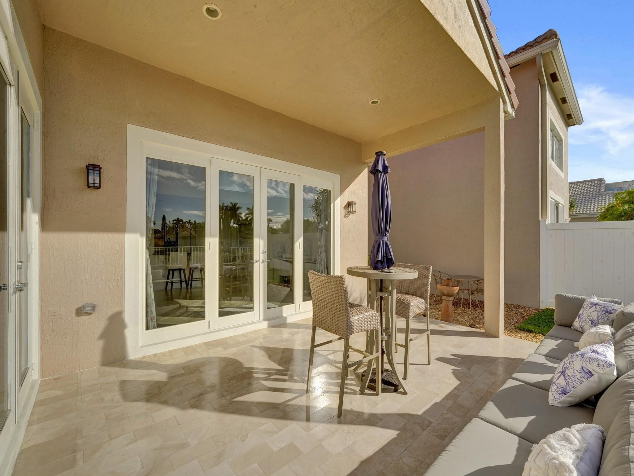 6298 Brava Way Boca Raton, FL 33433 - Photo 69 of 91 a view of a patio with table and chairs and potted plants