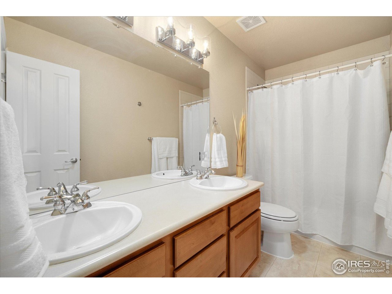 16836 Roberts Street Mead, CO 80542 - Photo 24 of 27 a bathroom with a sink a toilet and a mirror