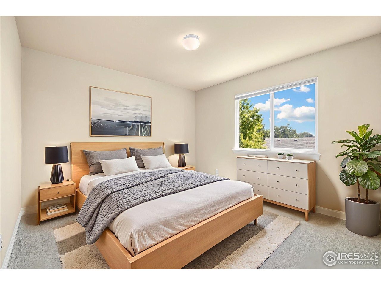 16836 Roberts Street Mead, CO 80542 - Photo 25 of 27 a bedroom with a large bed and potted plant