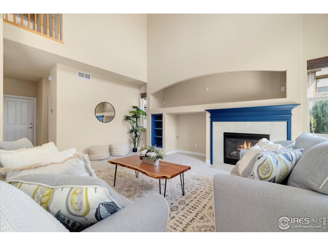 16836 Roberts Street Mead, CO 80542 - Photo 9 of 27 a living room with furniture a fireplace and a table