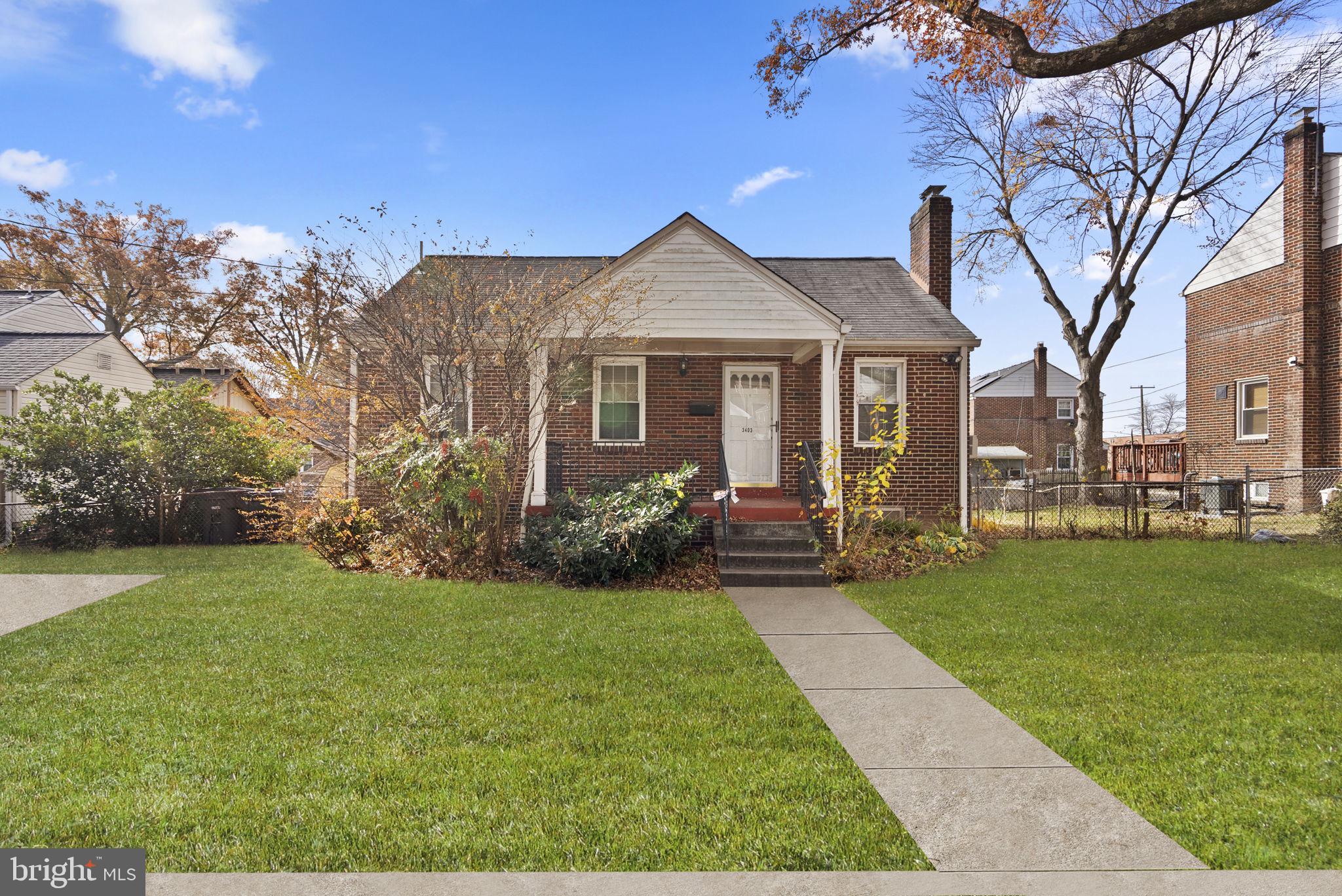 3403 Lancer Drive Hyattsville, MD 20782 - Photo 1 of 24 a front view of a house with a garden and yard