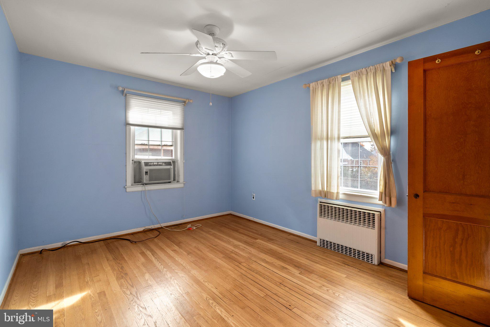 3403 Lancer Drive Hyattsville, MD 20782 - Photo 14 of 24 a view of an empty room with a window and wooden floor