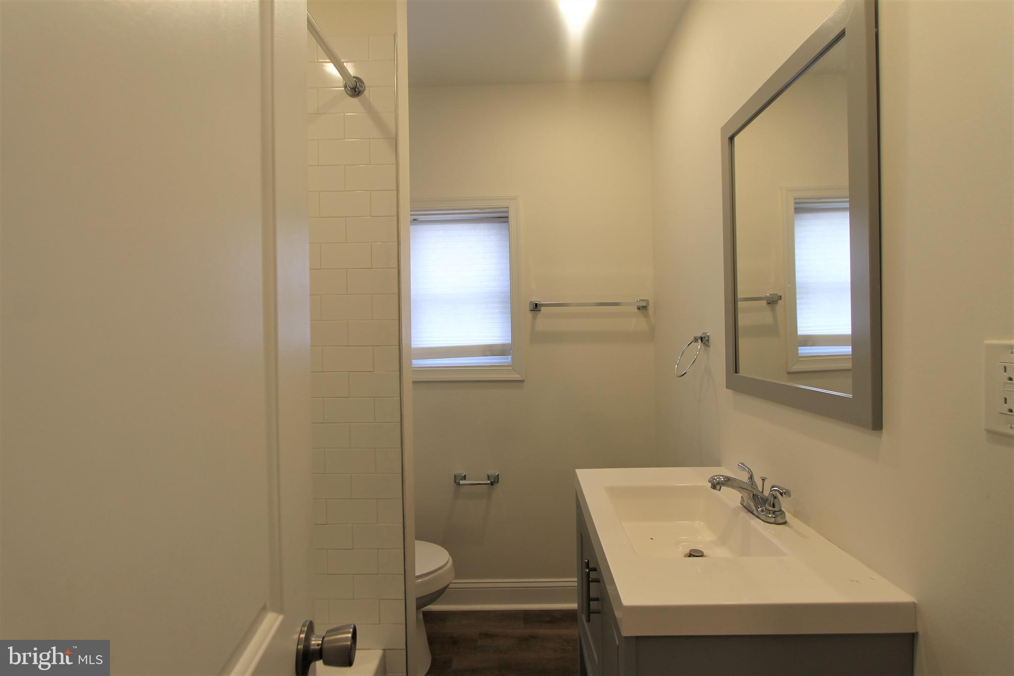 204 High Street Philadelphia, PA 19144 - Photo 15 of 19 a bathroom with a sink a toilet and mirror
