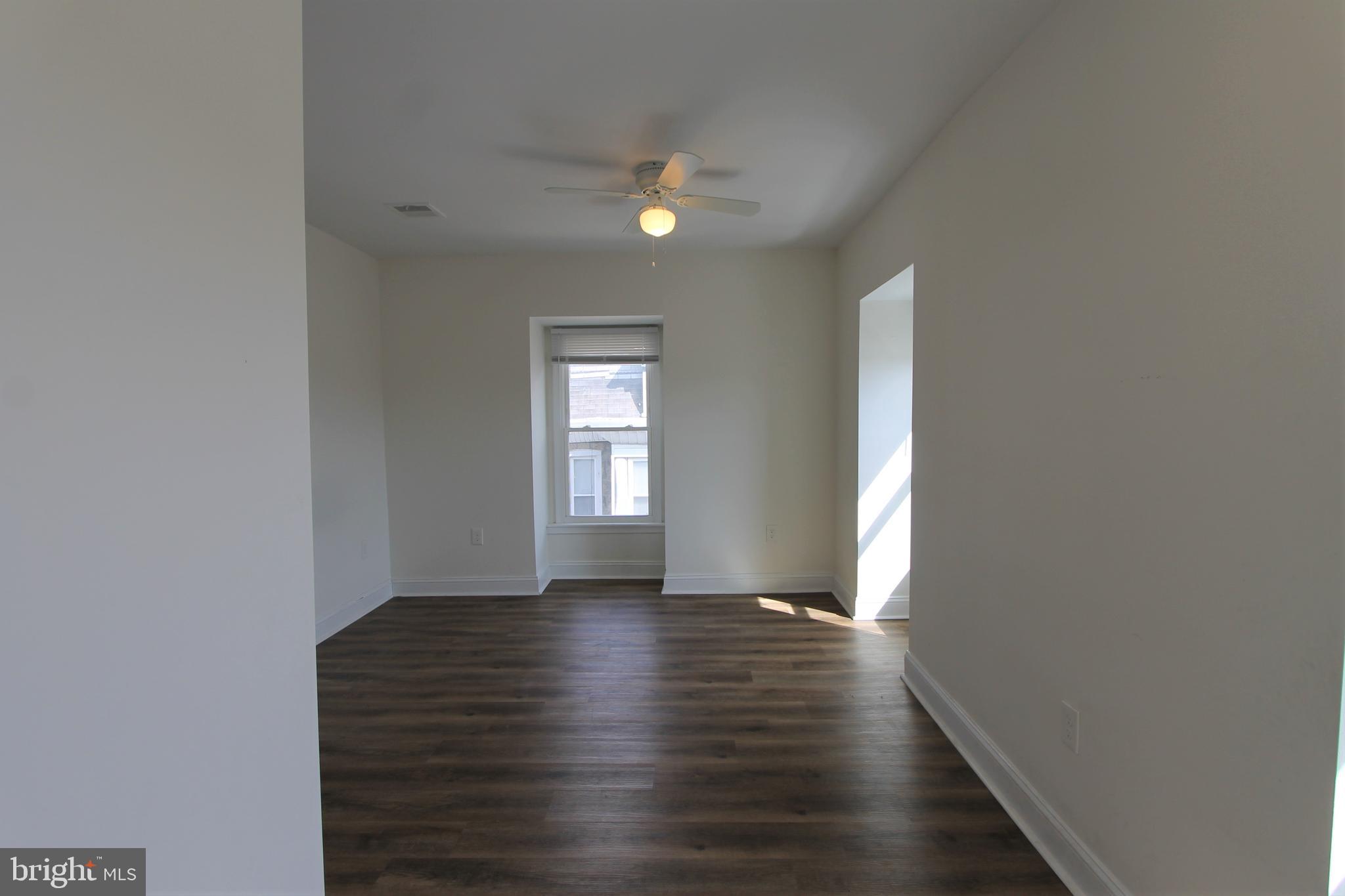 204 High Street Philadelphia, PA 19144 - Photo 17 of 19 a view of an empty room with wooden floor and a window