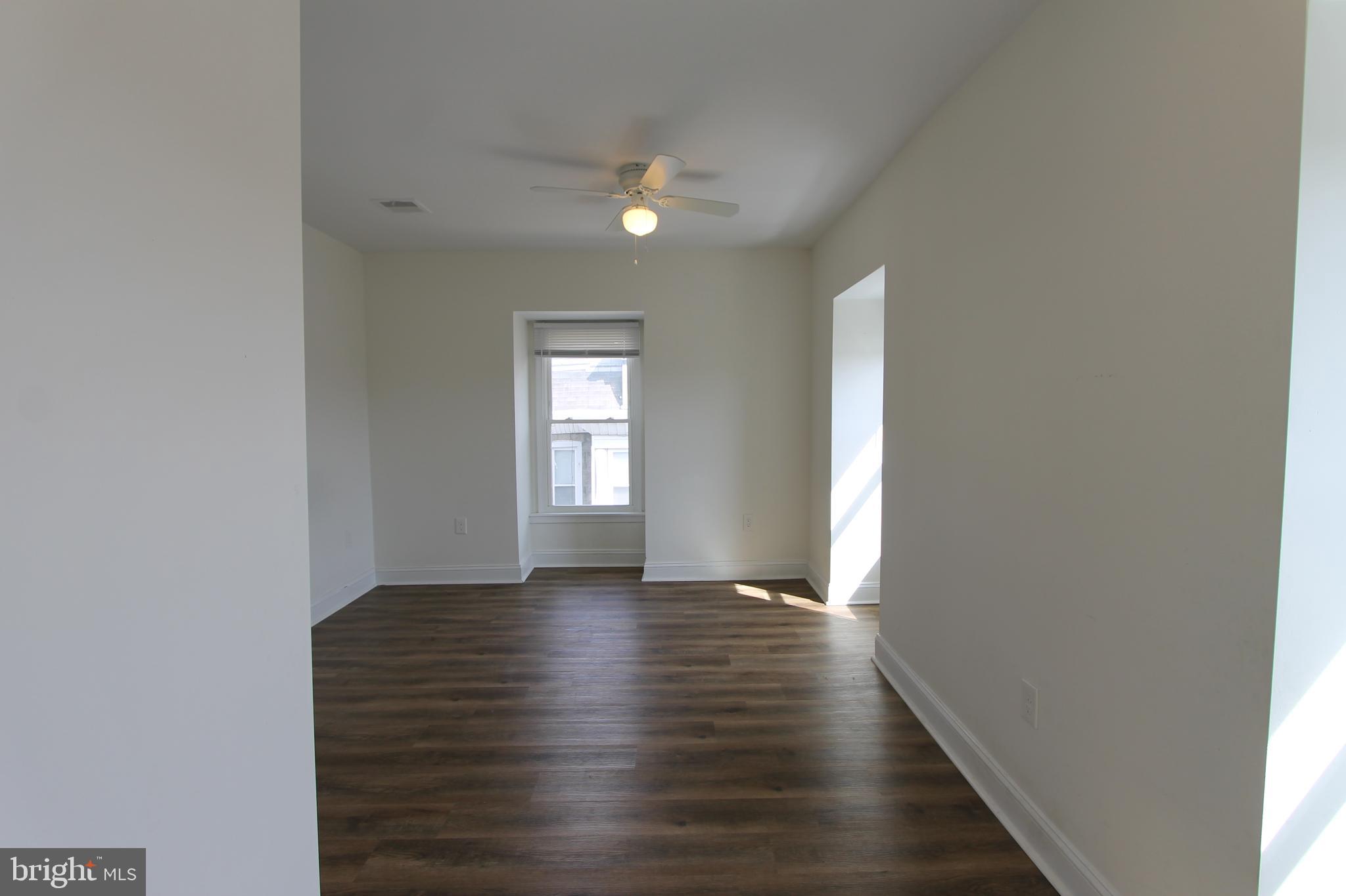 204 High Street Philadelphia, PA 19144 - Photo 18 of 19 a view of an empty room with wooden floor and a window