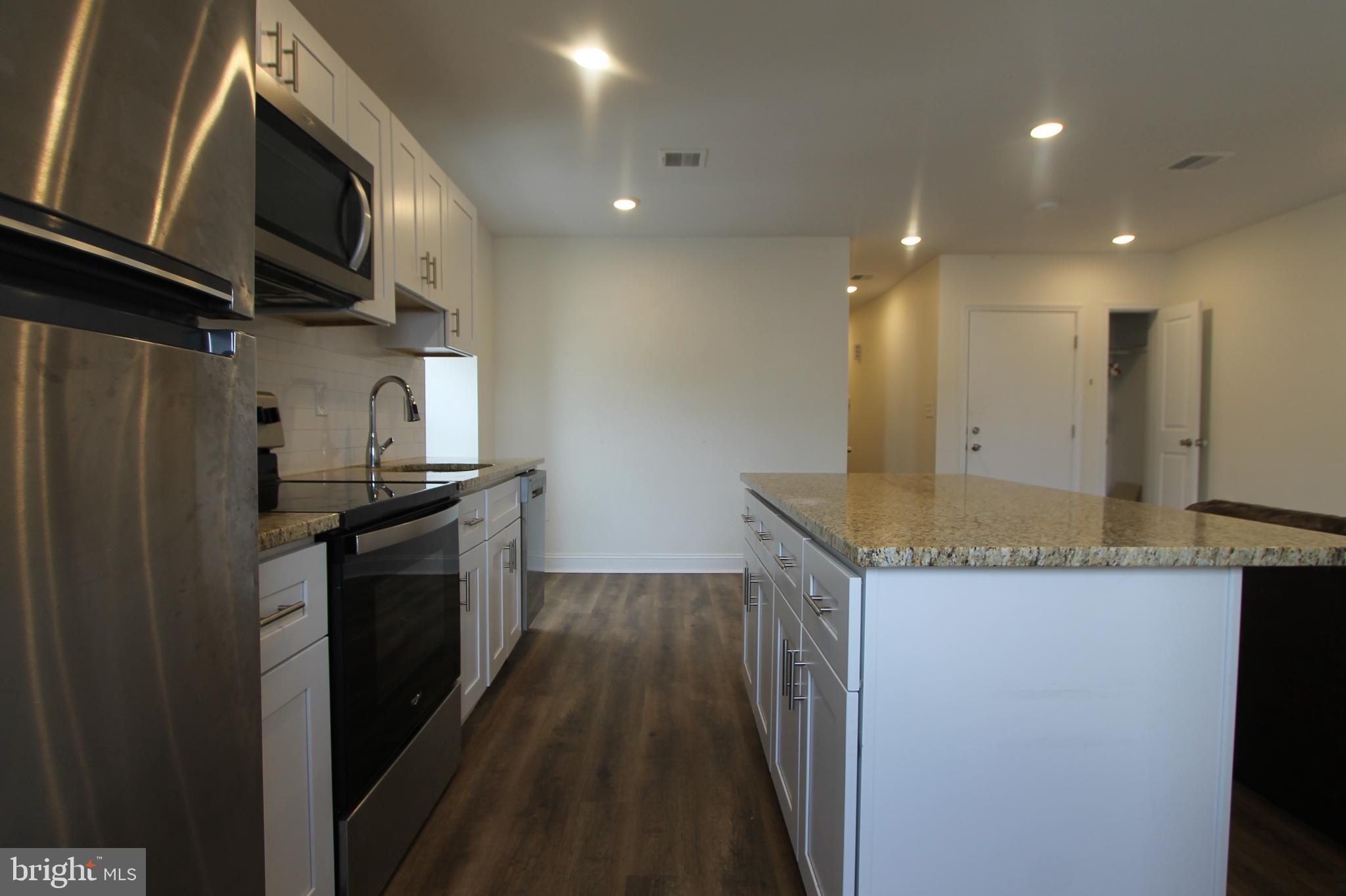 204 High Street Philadelphia, PA 19144 - Photo 7 of 19 a kitchen with stainless steel appliances granite countertop a refrigerator a sink and a stove