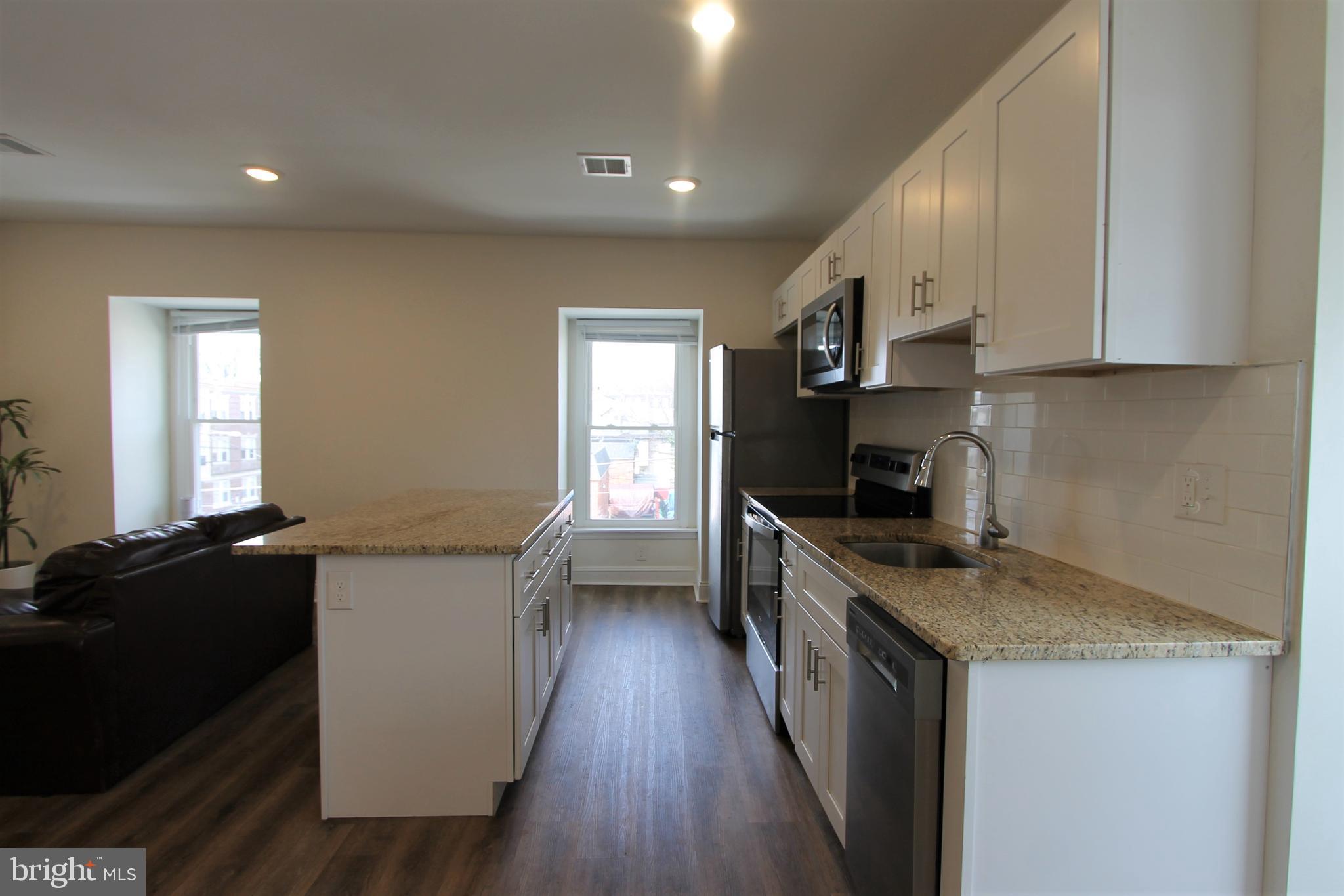 204 High Street Philadelphia, PA 19144 - Photo 9 of 19 a kitchen with stainless steel appliances a sink stove and cabinets