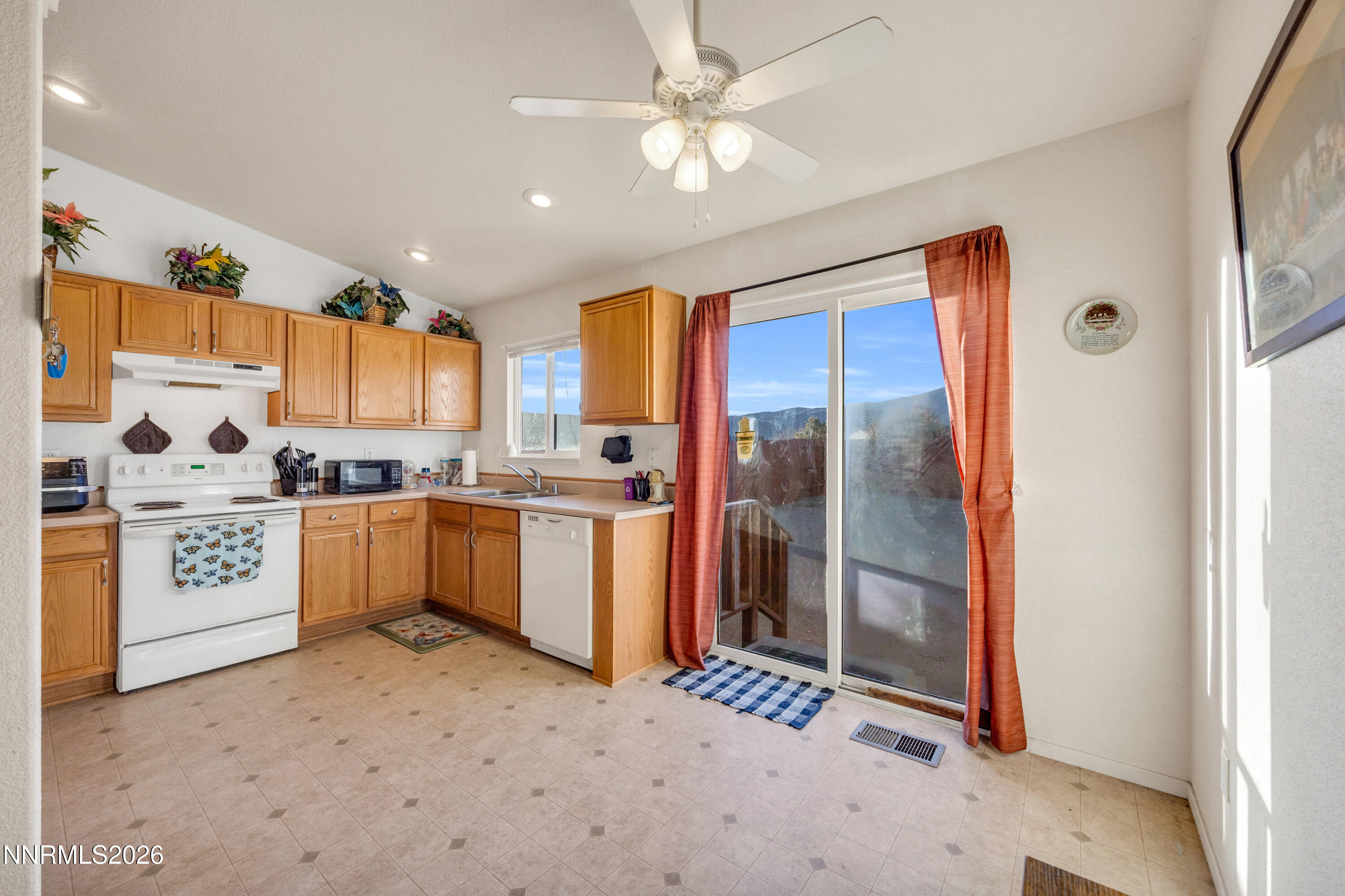 17391 Desert Lake Drive Reno, NV 89508 - Photo 11 of 39 a kitchen with a refrigerator a sink and cabinets