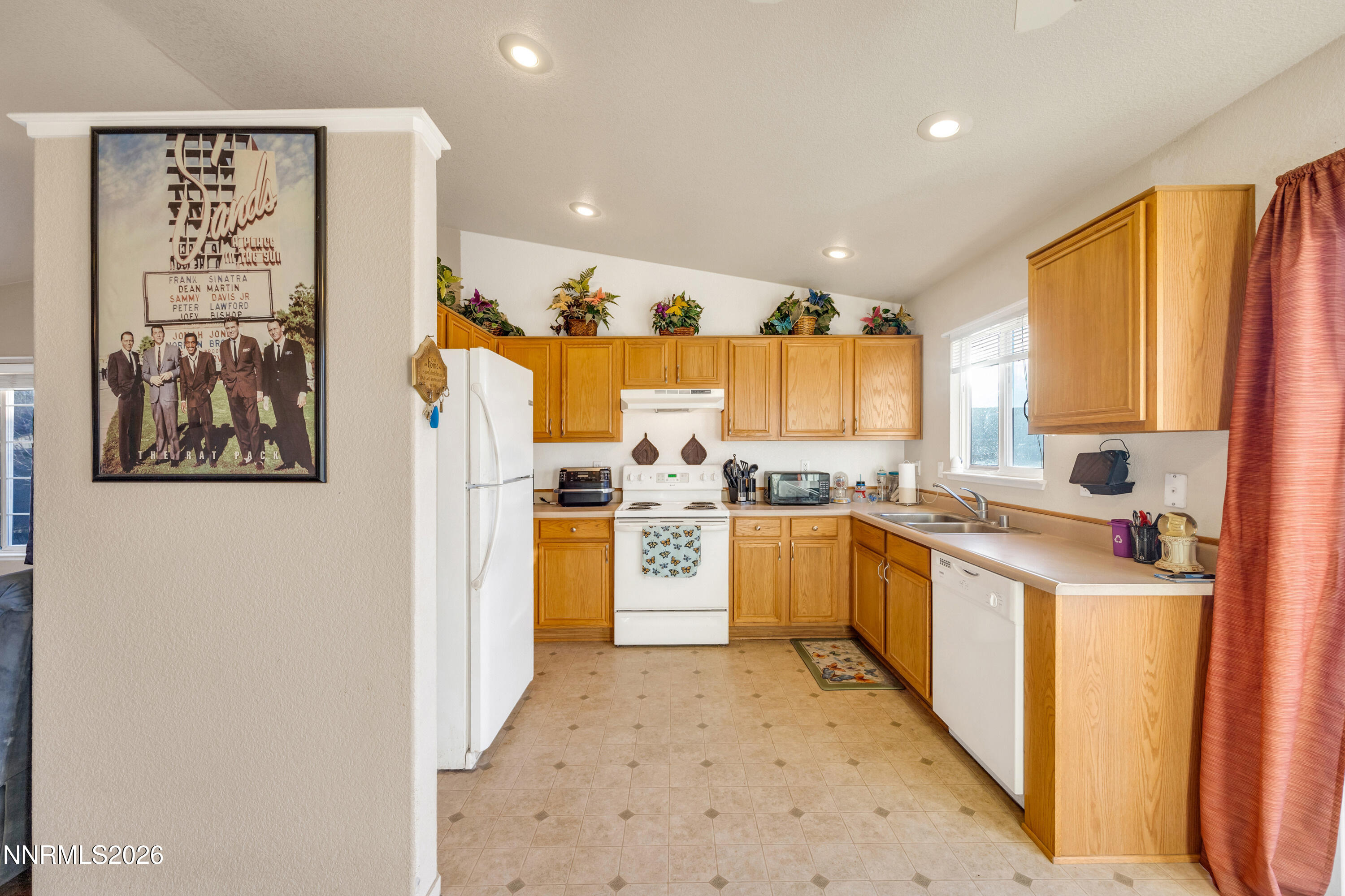 17391 Desert Lake Drive Reno, NV 89508 - Photo 12 of 39 a kitchen with a refrigerator and a sink