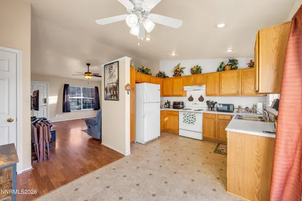 a kitchen with stainless steel appliances kitchen island granite countertop a refrigerator and a sink