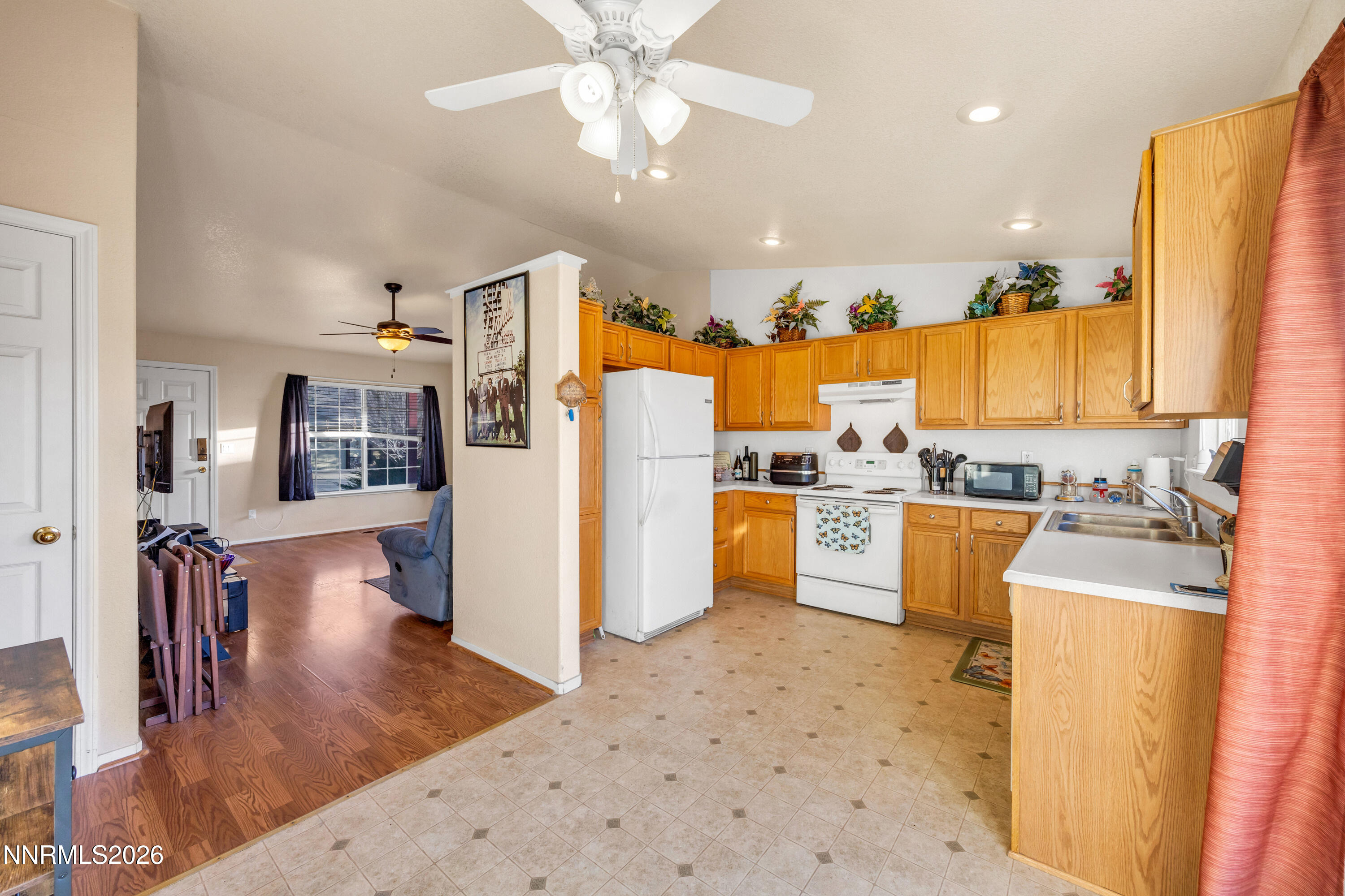 17391 Desert Lake Drive Reno, NV 89508 - Photo 13 of 39 a kitchen with stainless steel appliances kitchen island granite countertop a refrigerator and a sink