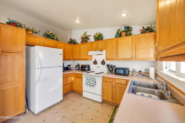 a kitchen with stainless steel appliances a refrigerator sink and cabinets