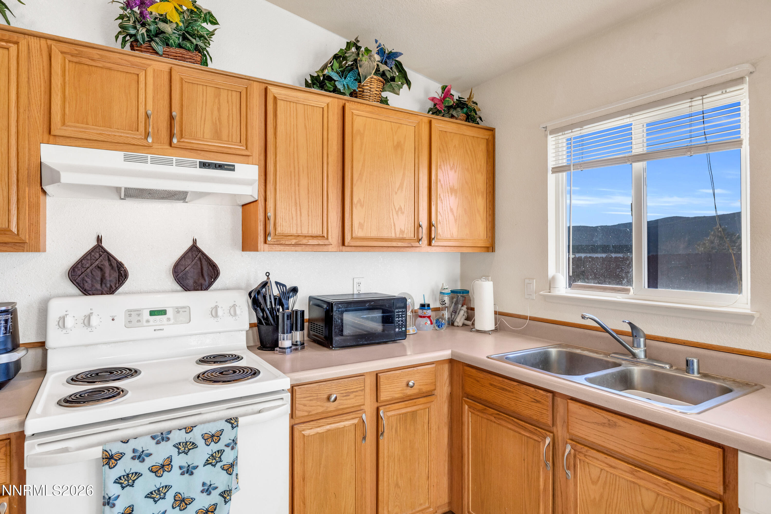 17391 Desert Lake Drive Reno, NV 89508 - Photo 15 of 39 a kitchen with stainless steel appliances granite countertop a sink stove and cabinets