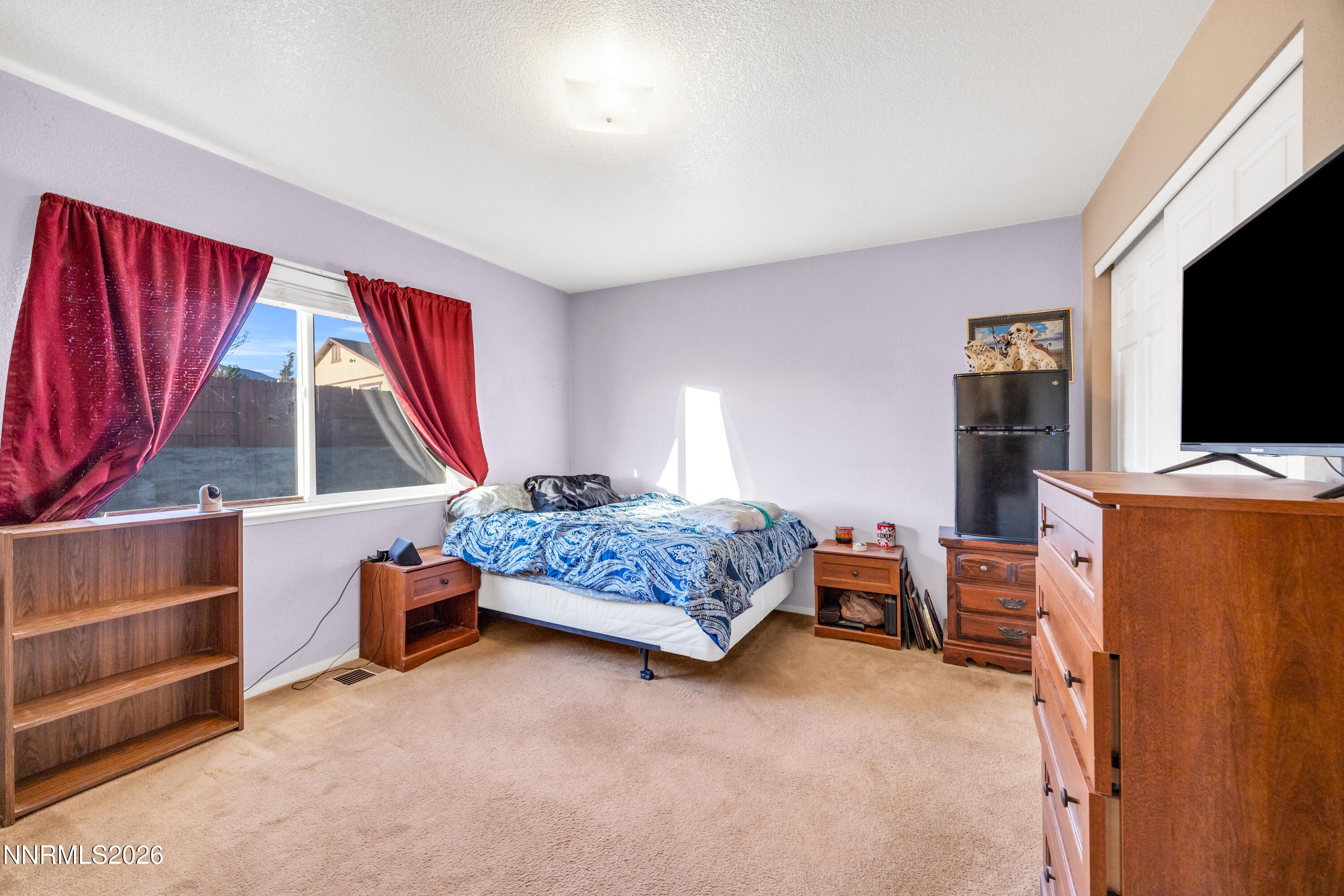 17391 Desert Lake Drive Reno, NV 89508 - Photo 17 of 39 a bedroom with a bed and a flat screen tv