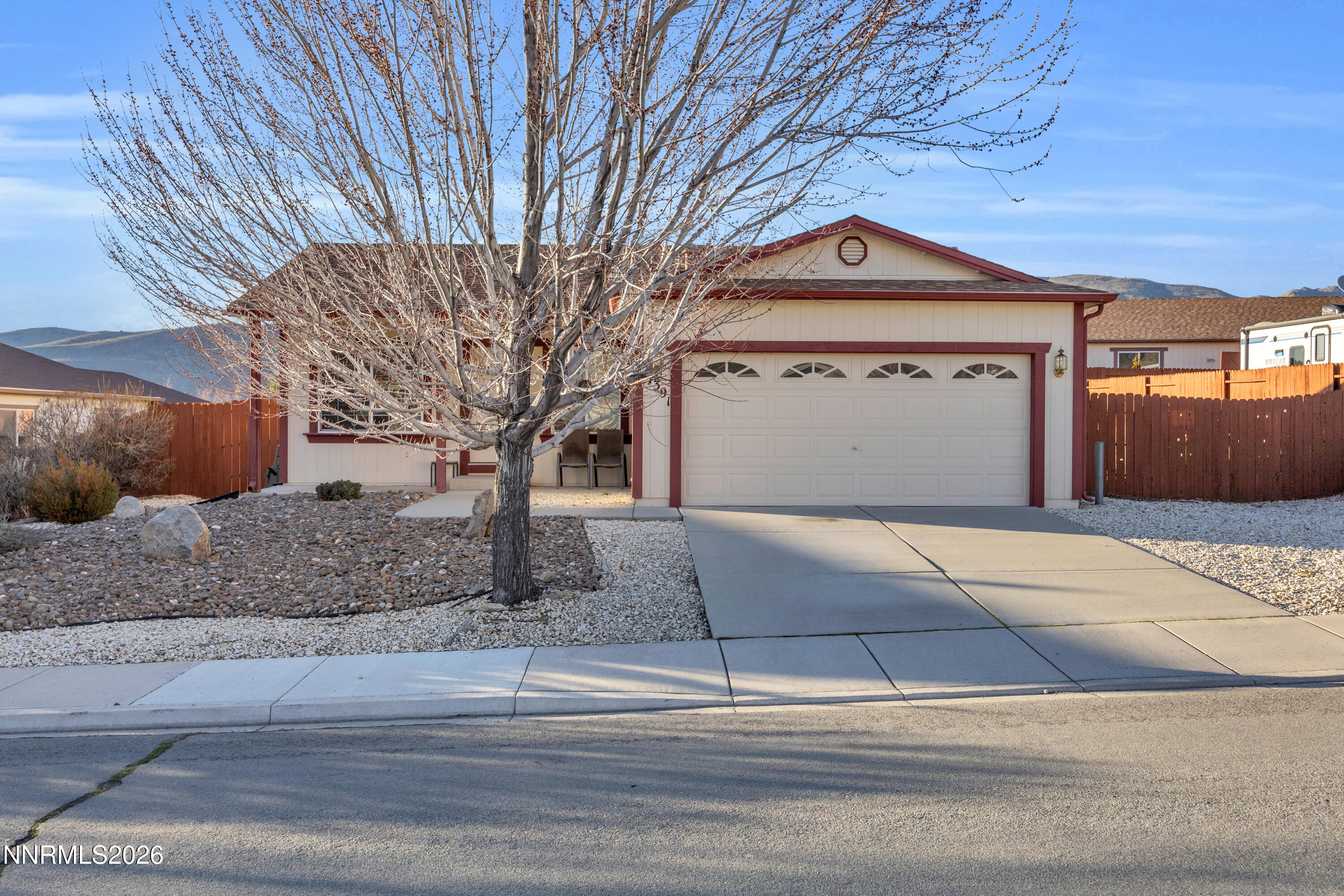 17391 Desert Lake Drive Reno, NV 89508 - Photo 2 of 39 a front view of a house with a yard and garage