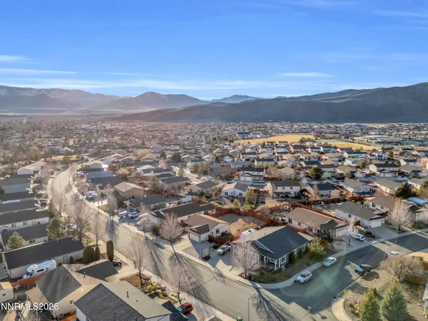 an aerial view of residential houses with city view