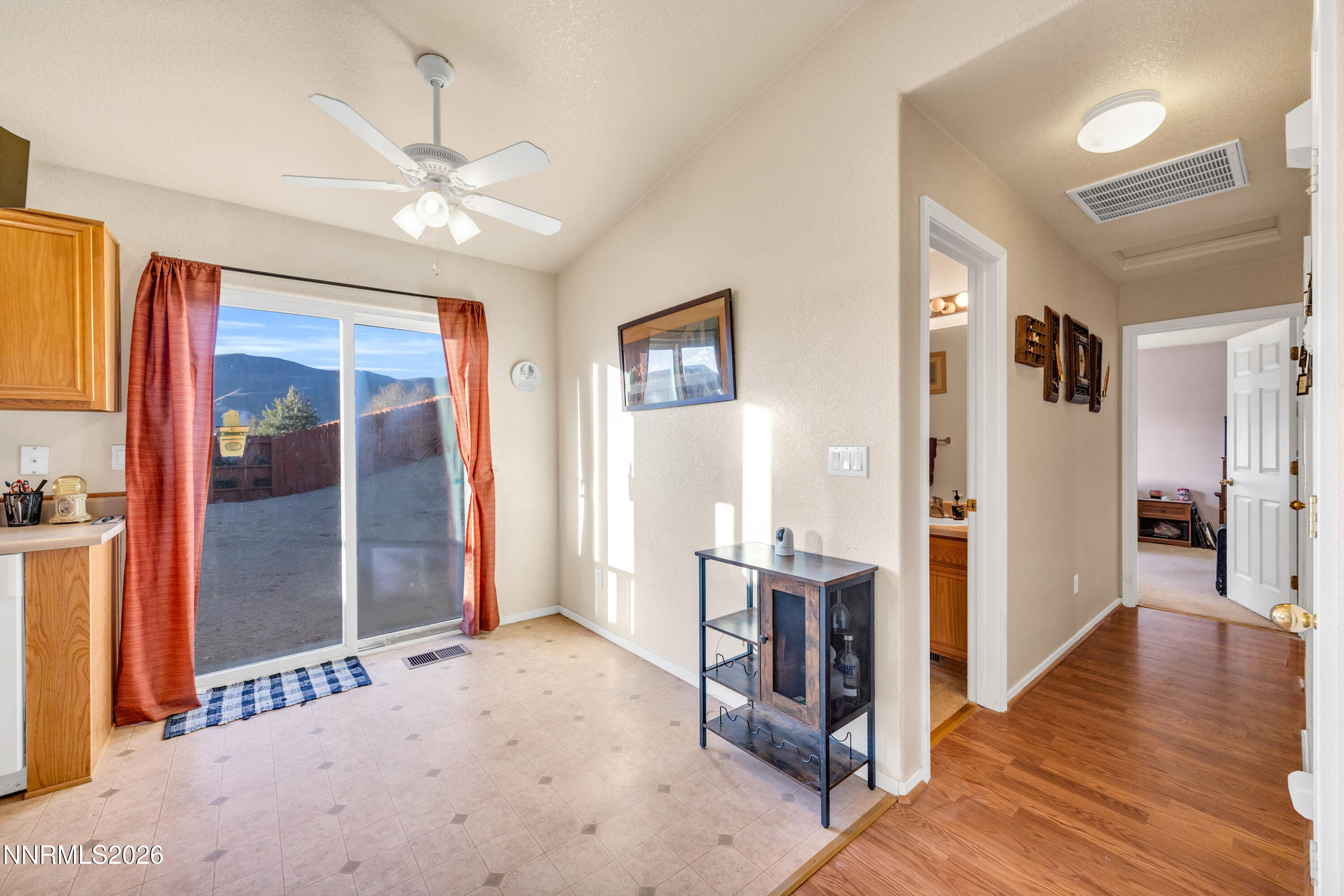 17391 Desert Lake Drive Reno, NV 89508 - Photo 9 of 39 a view of a livingroom with wooden floor and kitchen space