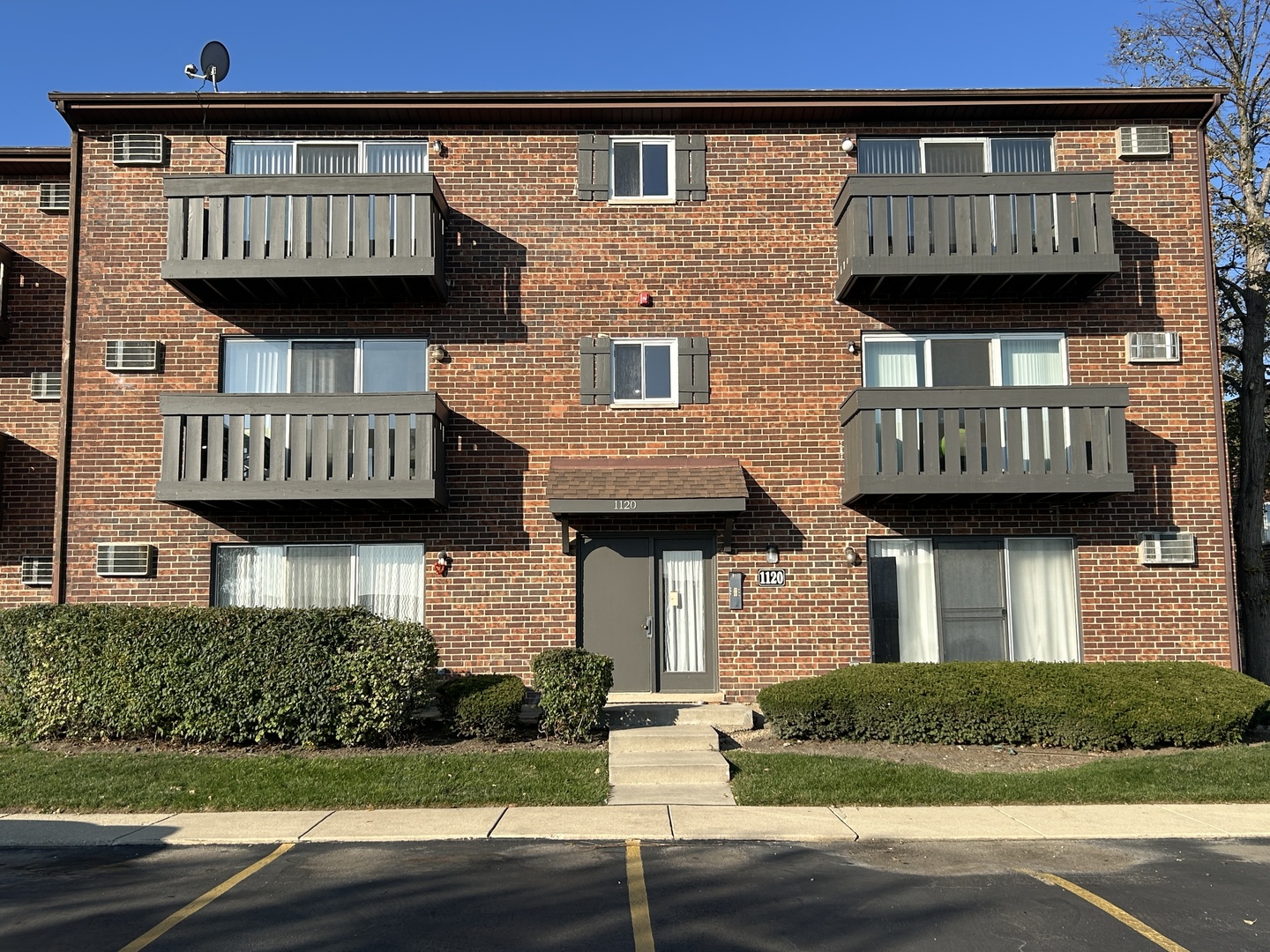 1120 Copperfield Lane, Unit E Schaumburg, IL 60193 - Photo 1 of 9 a view of a brick building with many windows