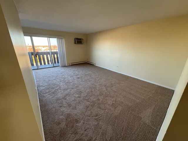 a view of an empty room and a window