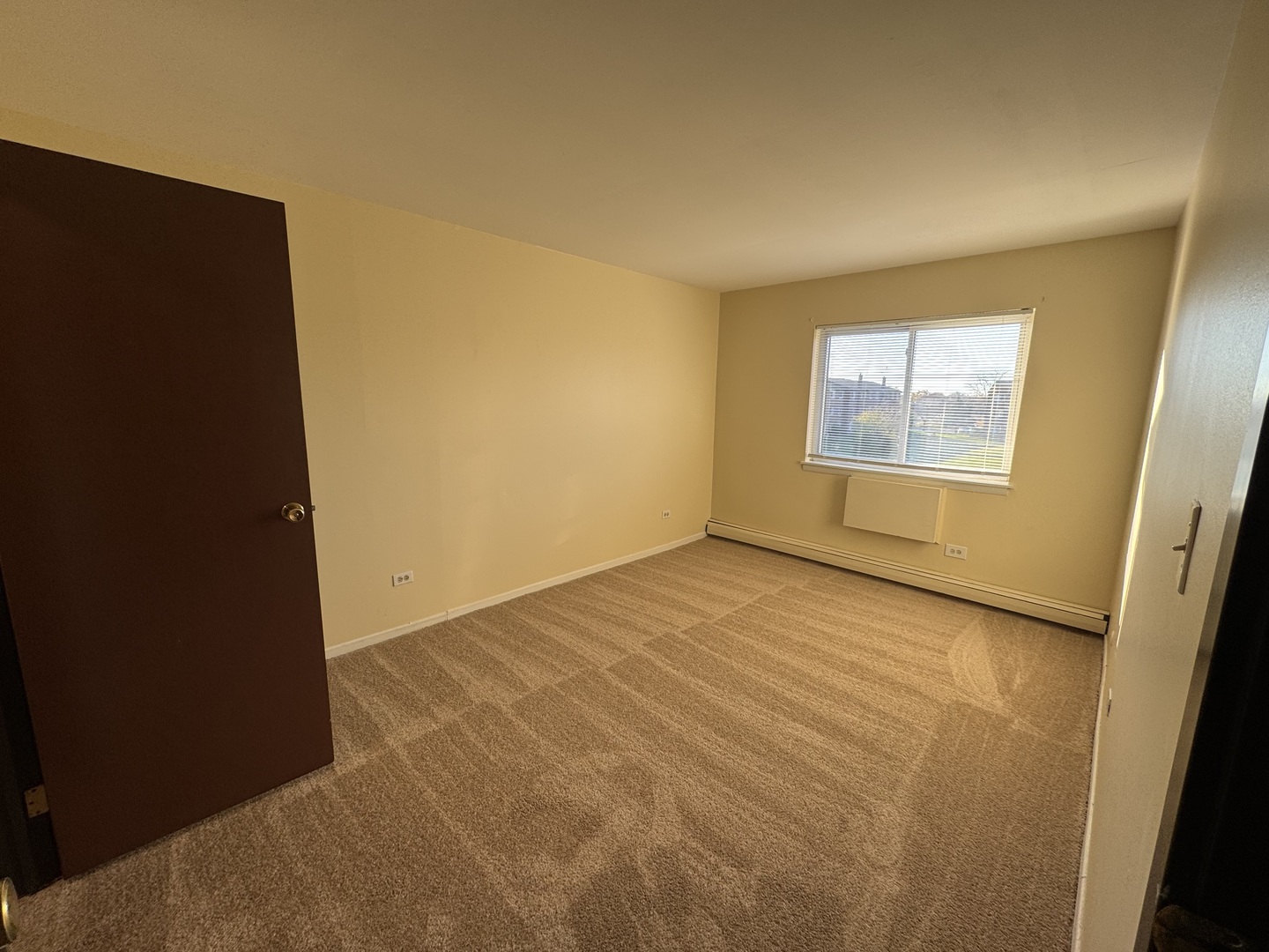 1120 Copperfield Lane, Unit E Schaumburg, IL 60193 - Photo 8 of 9 an empty room with windows