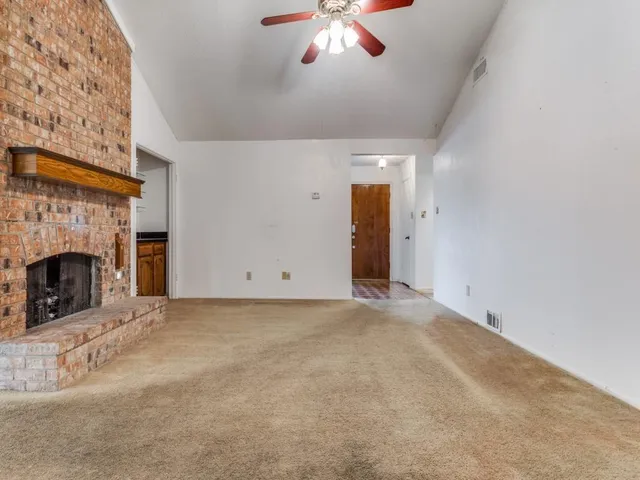 a view of empty room with window and fireplace