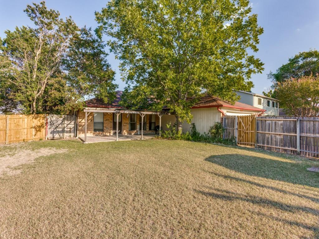 1807 Eldora Court Richardson, TX 75081 - Photo 23 of 23 a front view of a house with a garden