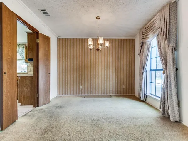 an empty room with windows and outdoor view