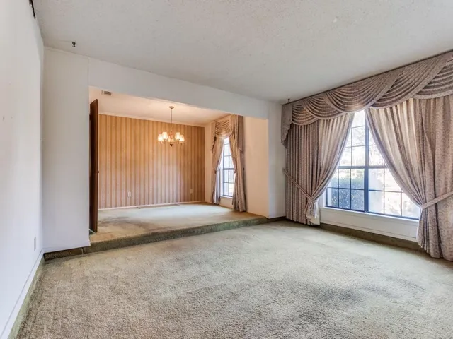 an empty room with windows and door