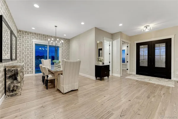 a view of a a dining room with furniture window and wooden floor