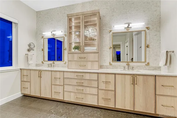 a bathroom with sinks mirror and a bathtub