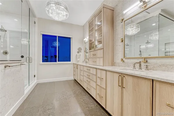 a bathroom with a glass shower door and a sink
