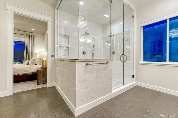 a bathroom with a granite countertop bathtub shower sink and mirror