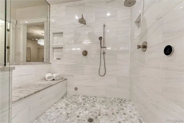 a bathroom with a double vanity sink a mirror and shower