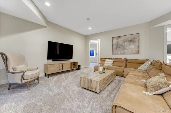 a living room with furniture a table and chairs