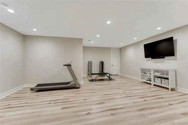 a bedroom with furniture and a flat screen tv