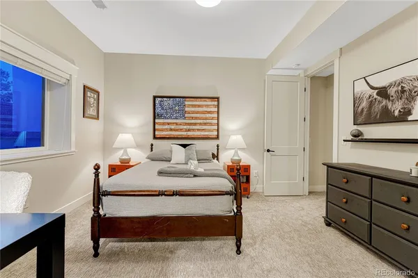 a bathroom with a toilet a sink a glass door a shower and a mirror