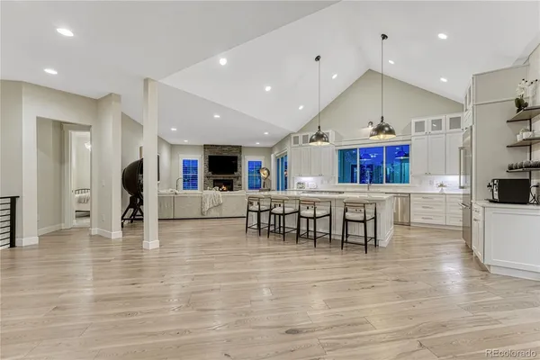 a large white kitchen with a large counter top cabinets and stainless steel appliances