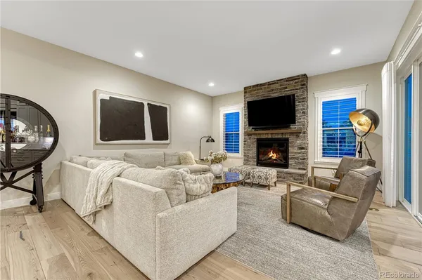 a living room with furniture and a view of kitchen