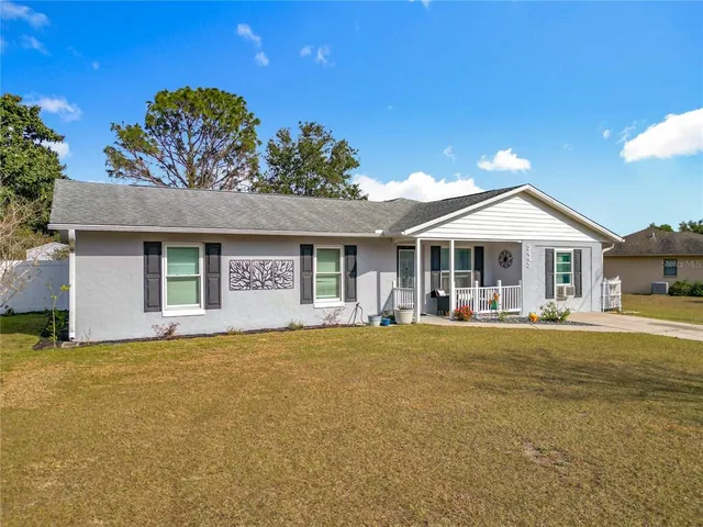 a front view of a house with a garden and porch