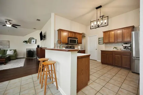 a kitchen with stainless steel appliances a microwave a stove a sink dishwasher a refrigerator and a microwave