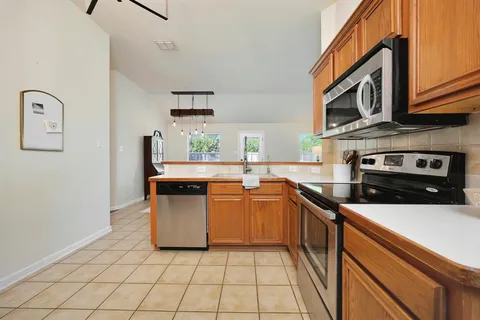 a kitchen with stainless steel appliances granite countertop a stove and a sink