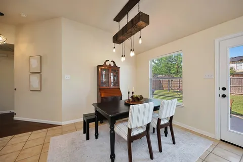 a view of a dining room with furniture and chandelier