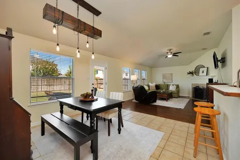 a living room with furniture a rug and a chandelier